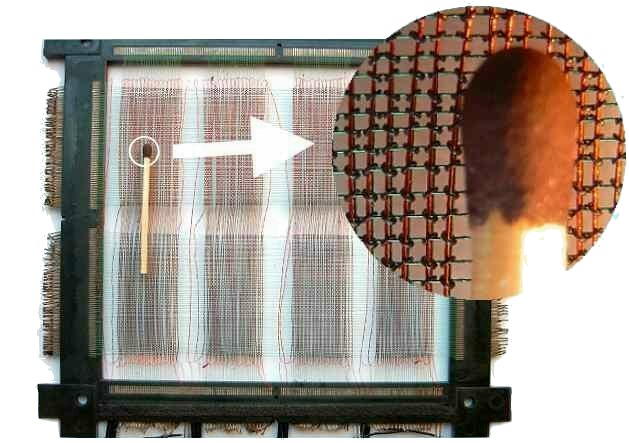 Photography illustrating the size of a core memory in contrast to a match